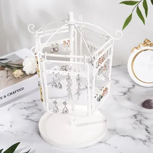 Rotating white iron jewelry stand detail with multi-layered earring storage holes