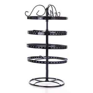Detail of four-tier rotating black metal earring organizer with hole-punched tiers