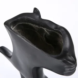 Top-down close-up of matte black resin necklace bust display showing internal texture