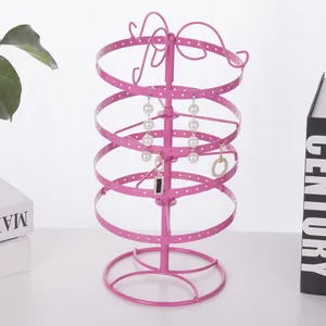 Rotating pink metal jewelry stand for earrings with four-tier circular display design