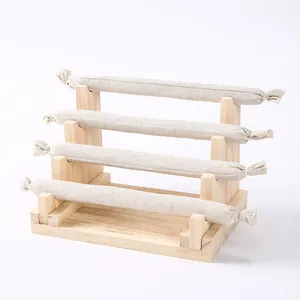 Detailed four-tier wooden jewelry stand with beige linen rolls for watches and bracelets