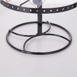 Close-up of a rotating earring display rack showing a stable round metal base