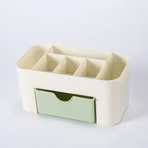 Detail view of cream desktop organizer with green drawer and six sorting compartments