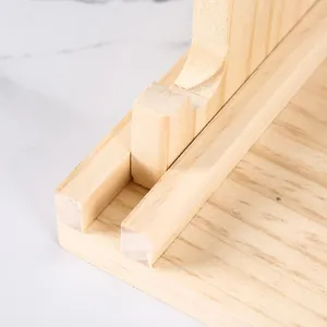 Detail of wooden jewelry stand showing precision slotting and natural wood grain finish