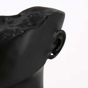 Close-up of matte black resin earring display stand with realistic ear detail and texture