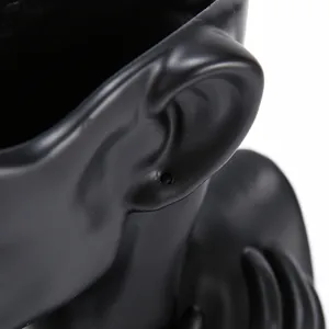 Detail of matte black ear-shaped mannequin stand for jewelry display and earrings