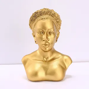 Dettaglio macro di un busto africano dorato in resina con finitura metallica
