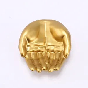 Detailed view of resin hand-shaped jewelry holder with matte golden finish display tray