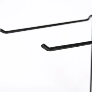 Detail of black iron jewelry stand hooks with non-slip curved ends and matte finish