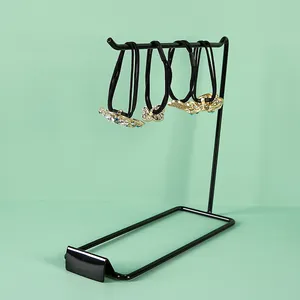 Close-up of elegant black elastic hair ties with crystal flower and butterfly charms