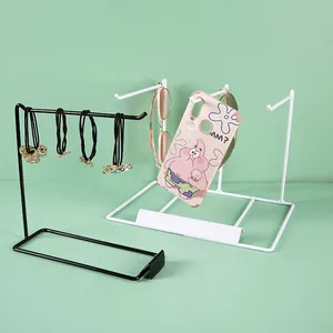 Close-up of metal jewelry display stand with hooks for hair ties and accessories