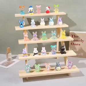 Macro view of 25 mini cartoon resin figures displayed on a 5-tier wooden trapezoid stand