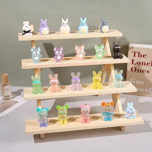 Detailed view of colorful cyberpunk animal figurines on a solid wood tiered display stand