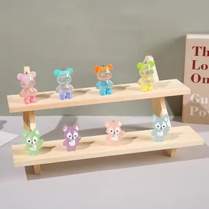 Solid wood tiered display stand holding colorful resin bear and fox pendants
