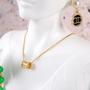 Elegant gold necklace and pearl earrings with crystal details on a jewelry display
