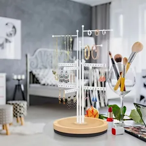 Three-tier white metal jewelry organizer with wooden base for earrings and necklaces