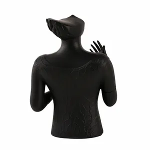 Detailed view of black resin jewelry display stand with elegant water wave textures