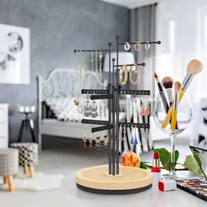 Rotating jewelry display stand with multi-tier metal hooks and a wooden base for earrings