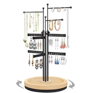 Rotating metal jewelry display stand with wooden base and multi-tier earring necklace hooks