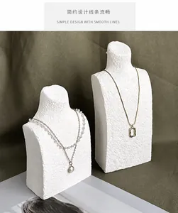 Detail of layered pearl and gold pendant necklaces on resin portrait jewelry busts