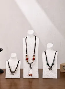Three-piece set of white resin bust stands for necklaces with realistic stone texture finish