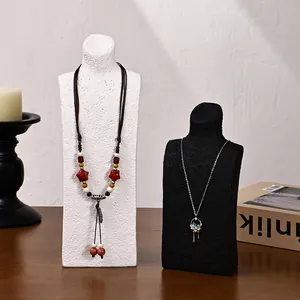 Vertical mannequin necklace display stands in black and white with vintage jewelry styles