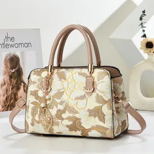Elegant floral handbag with embroidery, top handle and strap in minimalist setting