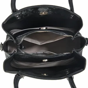 Interior view of black tote bag showing zipper compartment and magnetic snap closure