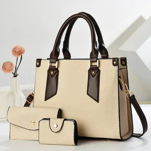 Close-up of three-piece set with beige woven texture, brown leather trim, and gold hardware