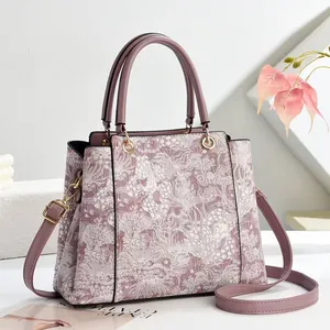 Elegant mauve floral lace tote bag with gold hardware and removable shoulder strap