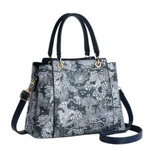 Blue and white printed PU leather handbag with dual handles and gold-tone hardware