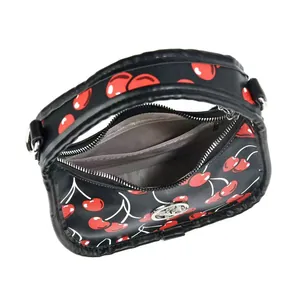 Detail view of the black cherry print bag showing zipper opening and gray interior lining