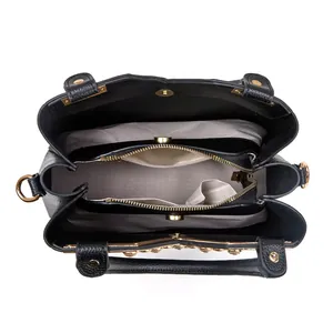 Detail view showing internal compartments and textured lining of the black leather bag