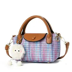 Pink woven tweed handbag with brown leather trim and cute plush charm attachment
