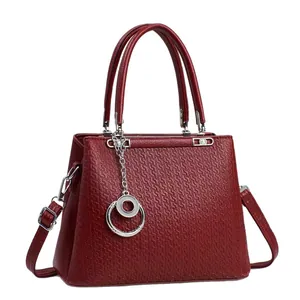 Fashionable dark red embossed leather tote bag with silver chain and detachable strap