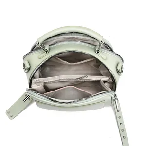 Top view of mint green crossbody bag showing internal compartments and chevron lining