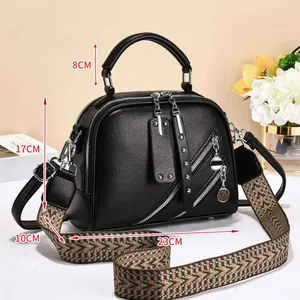 Detailed view of black litchi leather bag dimensions 23x17x10cm with patterned strap
