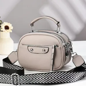 Three-layer faux leather crossbody bag in beige with wide herringbone canvas strap