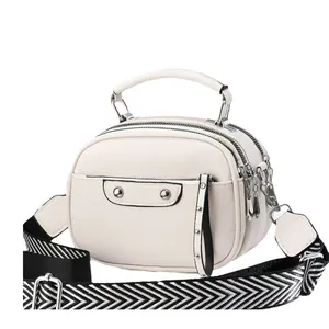 Three-layer creamy white crossbody bag with lychee texture and geometric stripe strap