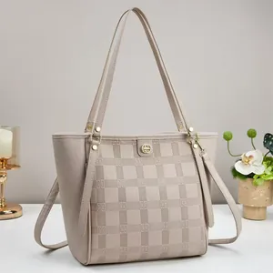 Beige oversized tote bag in lychee leather with checkered texture and gold hardware