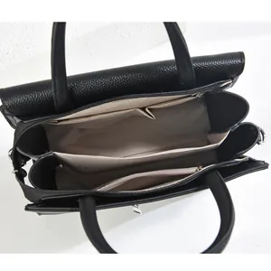 Internal view of black pebble leather tote with three compartments and grey lining