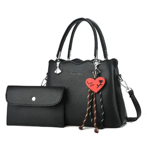 Black pebbled leather tote bag with Fashion Bags print and heart pendant charm