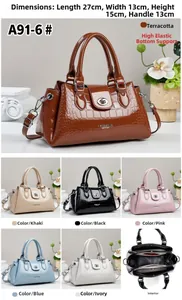 Detail view of crocodile embossed leather handbag with internal compartments and six colors