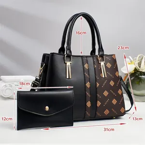 Detail view of a dual-bag set showing size dimensions and gold logo on black faux leather