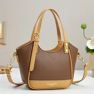 Chic two-tone contrast crossbody bag in brown and tan pebbled leather with gold hardware