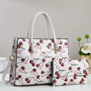 White cherry print handbag and matching long wallet set with gold-tone hardware detail