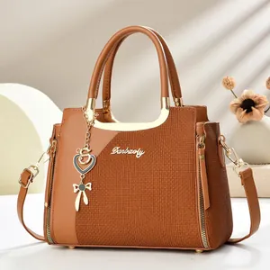 Modische braune Handtasche mit Kontrastnaht, gewebter Textur und goldenen Metallanhängern
