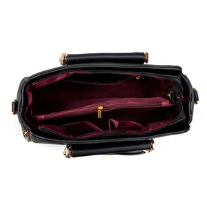 Top view of black tote bag interior featuring dark red lining and gold zipper pockets