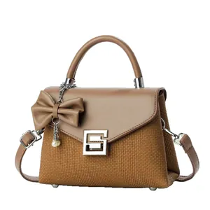 Elegant contrast color leather handbag with weave texture and pearl bow charm