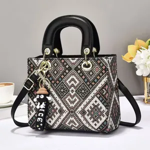 Elegant geometric pattern jacquard handbag with black leather handles and long strap